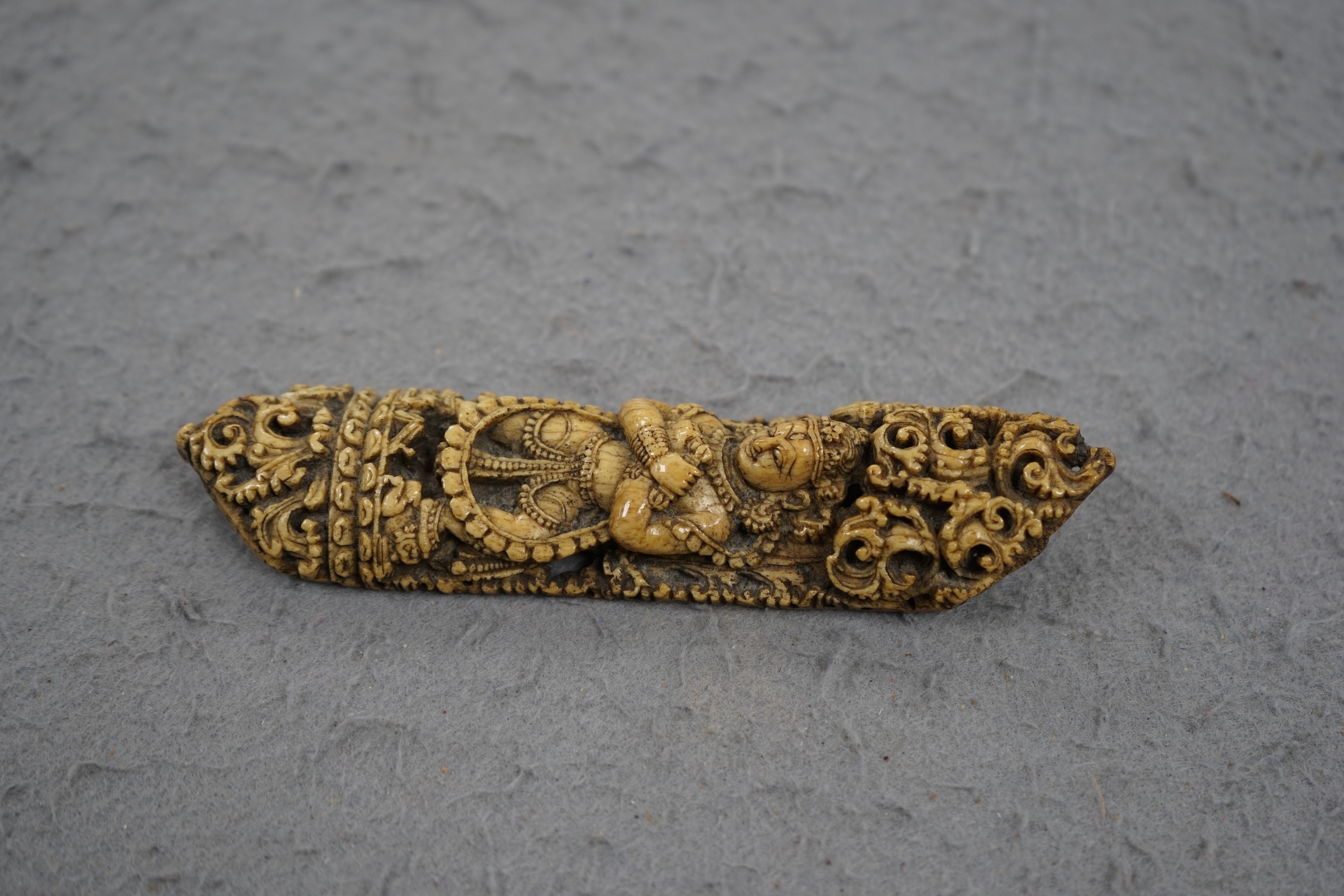 A 19th century Burmese bone carving of a Buddhist deity, 15cm tall